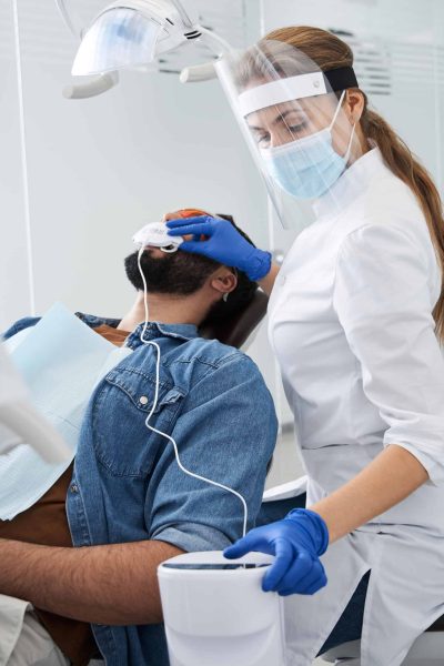 Man Undergoing Teeth Whitening Procedure